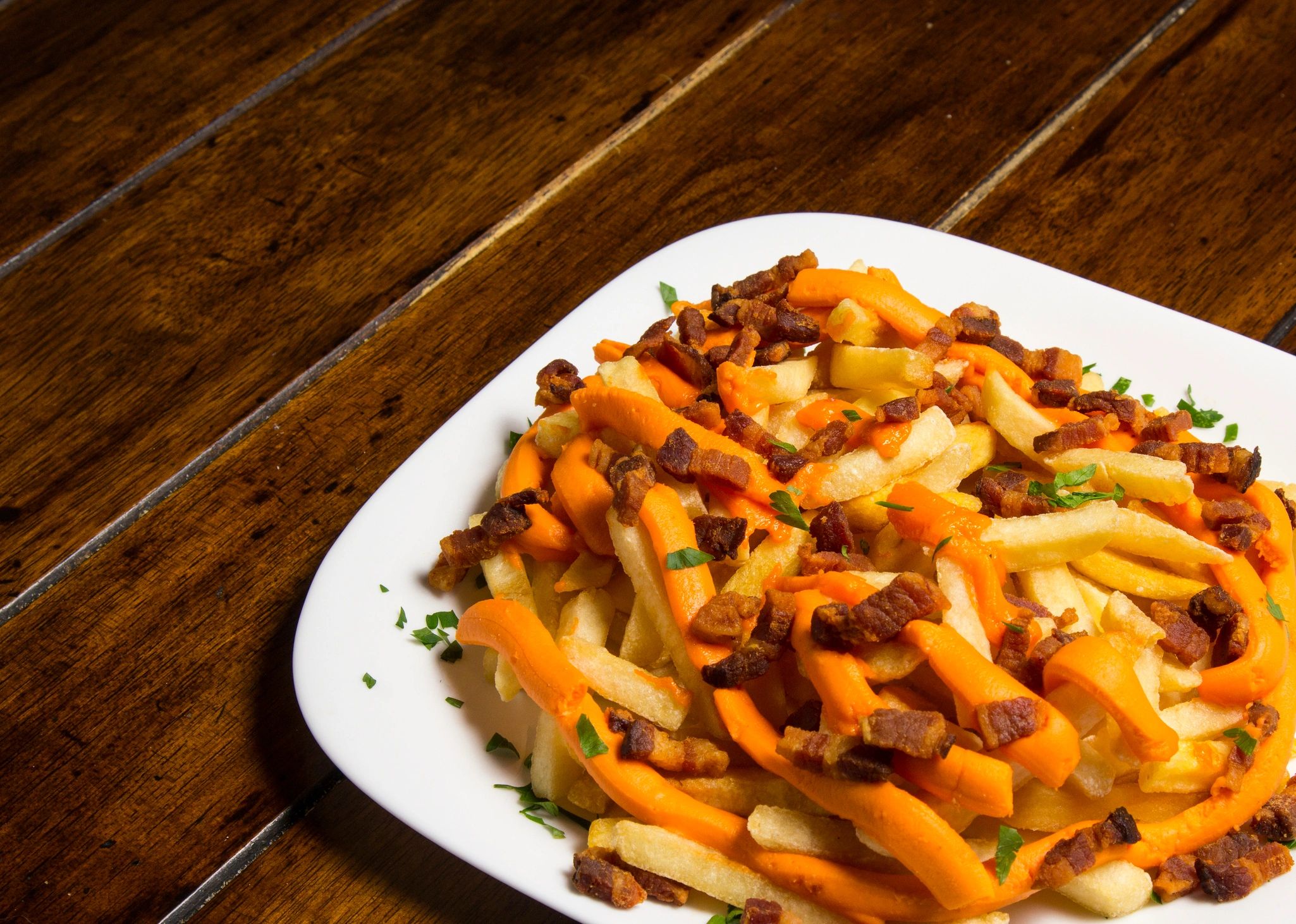 French fries topped with cheddar cheese and bacon