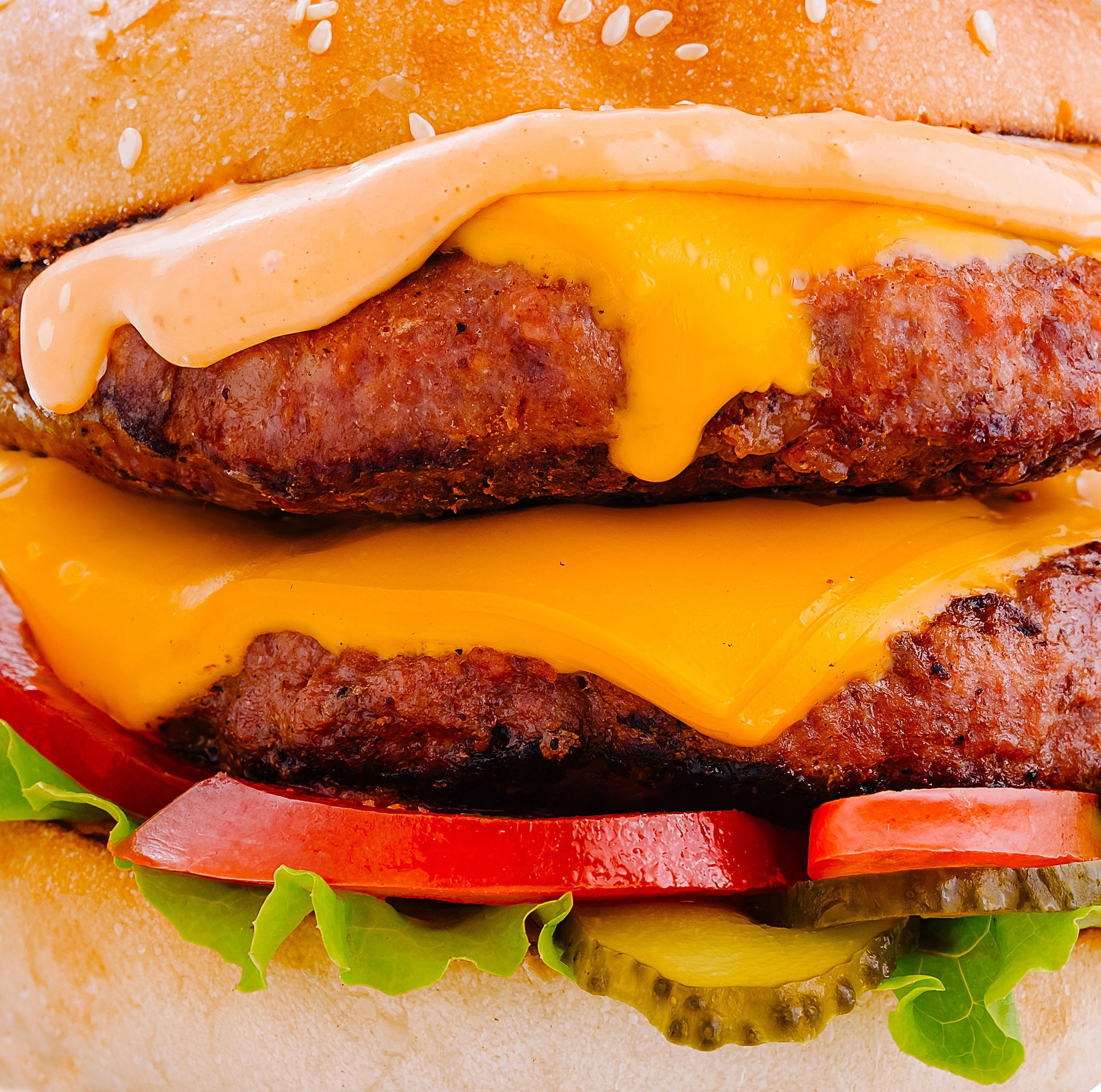 Cheesy gourmet burger used as a bold food visual